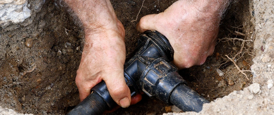 Irrigation professional repairing broken pipe for irrigation system in Baltic, SD.