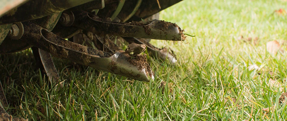 Close up on core aeration machinery in action on a property in Tea, SD.