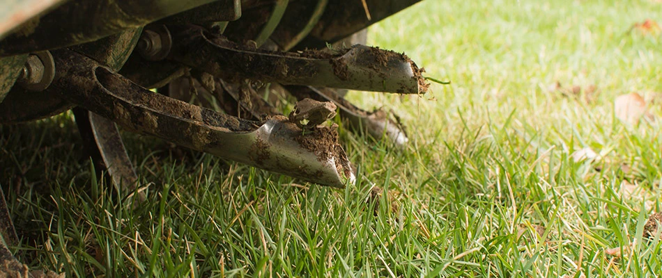 Aerator machine pulling out dirt in lawn in Harrisburg, SD.