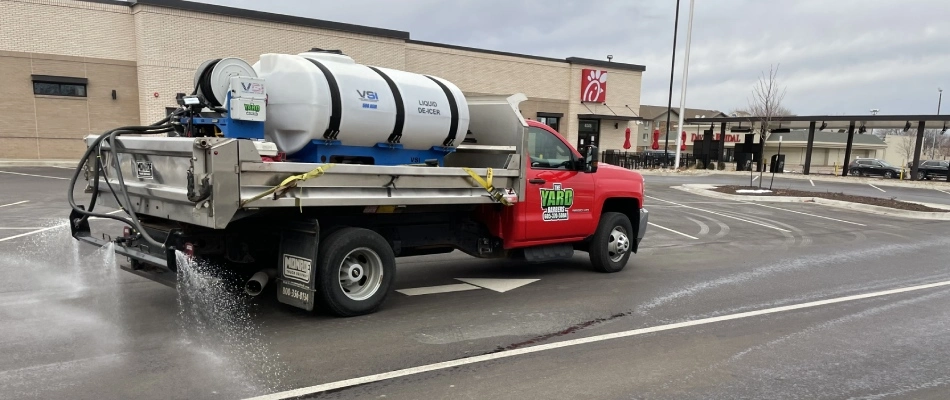 Deicing truck from Yard Barbers performing service for commercial property in Brandon, SD.